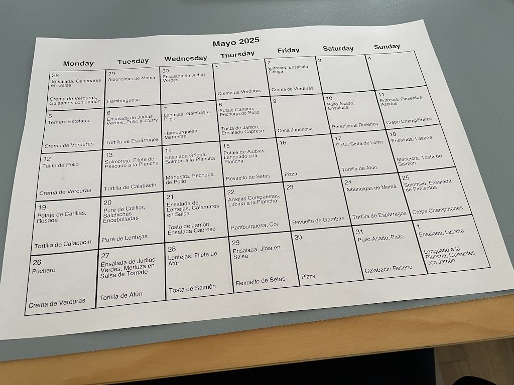 A printed calendar for May 2025 with lunch and dinner written in every day